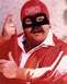 1989 Ford Bronco - A man in a red costume and mask, with the word 'CHAOS' on his cap, gestures towards the camera.