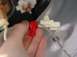 2003 Mazda 6 - A hand is shown connecting a red electrical connector to a white clip, likely part of a vehicle's wiring system.