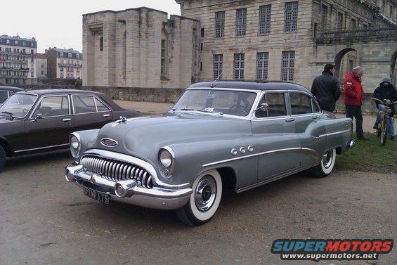1953 Buick Special sedan parked next to a Peugeot 504 sedan