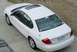 2003 Mazda 6 - A white sedan is parked on a concrete driveway, viewed from above.