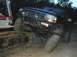 1996 Ford Bronco - A modified Ford Bronco is high-centered on the tracks of an excavator.