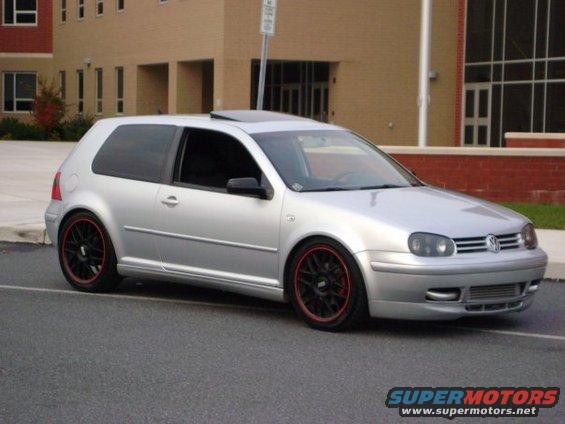 Silver Volkswagen Golf GTI with black BBS wheels and red trim, parked on asphalt