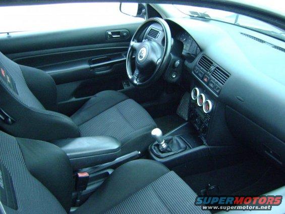 Interior view of a car with bucket seats and a manual shifter