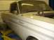 1964 Ford Ranchero - Side view of a 1964 Ford Ranchero in a garage, raised on a lift.
