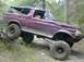 1996 Ford Bronco - This modified 1996 Ford Bronco is navigating an obstacle on an off-road trail.