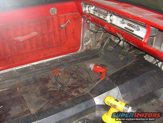1964 Ford Ranchero interior with red velour door panel, dashboard, and floor with tools