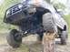 1996 Ford Bronco - This modified Ford truck is shown off-road, with one wheel resting on a large log.