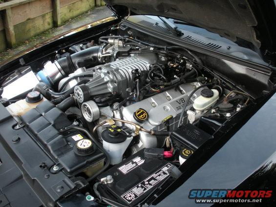 Ford V8 32 valve engine with supercharger, air intake, and battery
