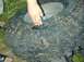 1996 Ford Bronco - A damaged tire lies on the ground, with a hand inspecting the large hole.
