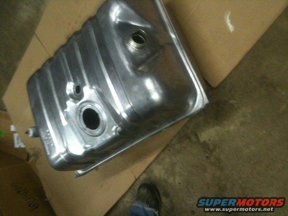 Metal fuel tank with ribbed sides and two circular openings