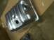 1993 Ford Bronco - A metal fuel tank is shown, likely for a vehicle, with visible ribbed texture and openings.