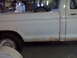 1973 Ford F-100 - 1973 Ford F-100 pickup truck side view with visible rust on the lower body panel.