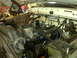 1973 Ford F-100 - The engine bay of a white truck is shown, various mechanical parts and wiring harnesses.