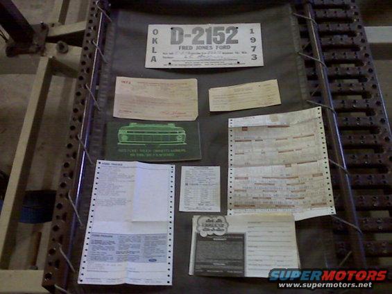 License plate D-2152 Fred Jones Ford 1973, plus various papers including a brochure with a truck grille