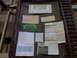 1973 Ford F-100 - A collection of vehicle-related documents, including a license plate and sales paperwork.