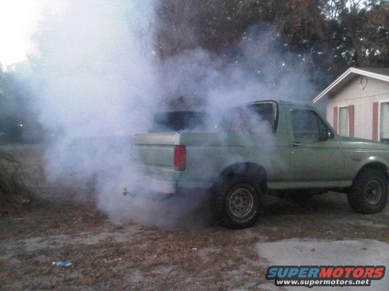1992 Ford Bronco emitting thick white exhaust smoke from the rear