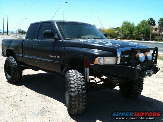 Black lifted Dodge Ram 2500 pickup truck with off-road tires and a bull bar