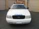 2002 Ford Crown Victoria - This police car, identified as a 2002 Ford Crown Victoria, is parked in front of garage doors.