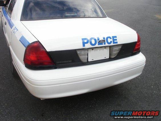 White police car rear with 'POLICE' text. 2002 Ford Crown Victoria