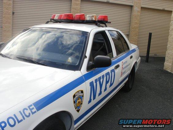 NYPD police car, front quarter view. Shows "POLICE" and "NYPD" markings