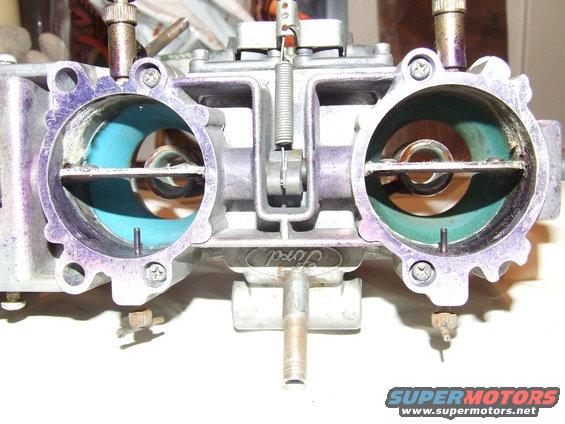 Ford carburetor with purple markings on the intake ports and green lining inside