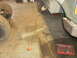 1995 Ford Bronco - A detached vehicle frame component lies on the garage floor next to tires and a toolbox.