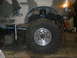 1995 Ford Bronco - A camouflaged Ford Bronco is shown from the side, lifted and supported by a jack in a workshop.