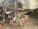 1995 Ford Bronco - Close-up view of the front axle and suspension system, likely undergoing modification or repair.