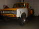 1971 International School Bus - International pickup truck with a white front fender, parked indoors.