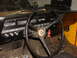 1971 International School Bus - The interior of a yellow vehicle shows the dashboard with gauges, steering wheel, and floor pedals.