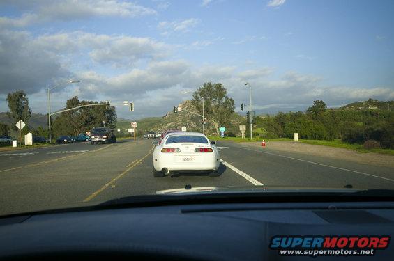 White Toyota Supra rear view on highway