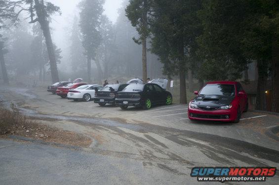 Red Subaru Impreza WRX with black hood, front view