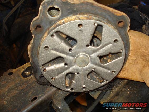 Water pump impeller with a metal fan and a rusty metal housing