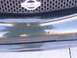 1978 Ford Bronco - Close-up of a Nissan grille and a damaged front bumper with visible paint chips.