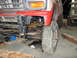 1984 Ford Bronco - Close-up of a Ford Bronco's front suspension and fender area, with visible leaf springs.