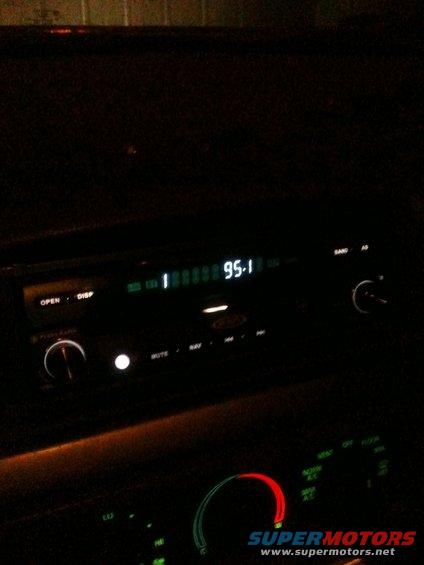 Car radio display shows 95.1 FM. Other buttons include OPEN, DISP, MUTE, NAV