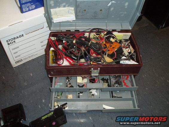 Open toolbox filled with wires, connectors, and electronic components