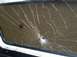 1978 Ford Bronco - The window is severely cracked, with the impact point visible in the center.