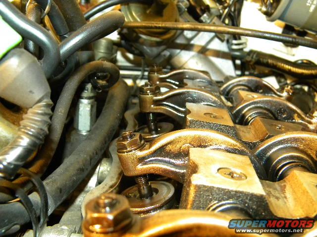 Close-up of engine valve train with visible oil