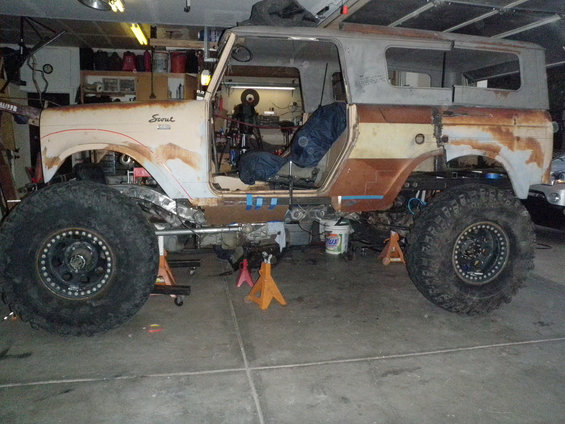 1961 International Scout 800 side view with large tires and lifted suspension