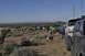 1991 Ford Bronco - Group of off-road vehicles gathered in a desert environment under a clear blue sky.