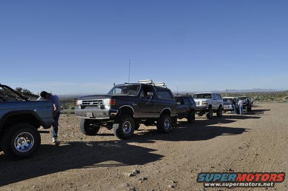 Dark SUV with roof rack parked on dirt road, 1992 model year