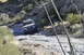 1991 Ford Bronco - SUV navigates a challenging rocky path in a desert environment.