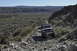 1991 Ford Bronco - A 1991 Ford Bronco navigates a challenging rocky path through a desert landscape.