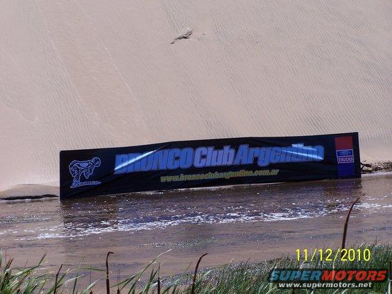 Bronco Club Argentina banner in water with sand dune background
