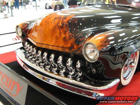 Black hot rod with flame paint and chrome grille, front view