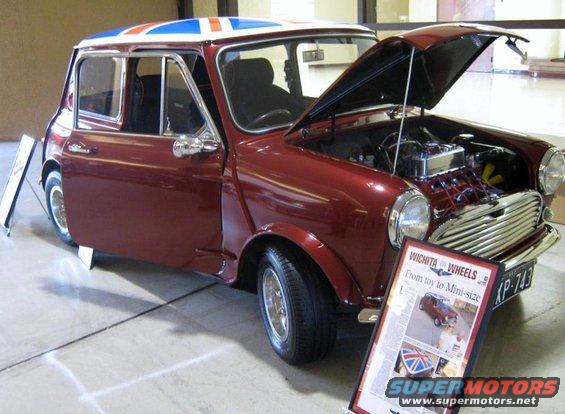 Maroon Mini Cooper with Union Jack roof, hood open showing engine