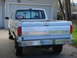 1989 Ford F-250 - Rear view of a white 1987 Ford F-250 pickup truck with a chrome bumper and a license plate.