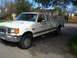1989 Ford F-250 - This white Ford F-250 pickup truck, seen from a 3q-front angle, appears to be from the 1987 model year, not 1989 as claimed.