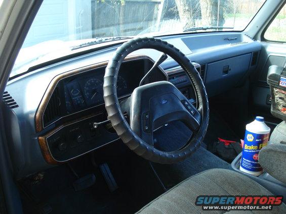 1989 Ford F-250 interior showing dashboard, steering wheel, and brake fluid bottle